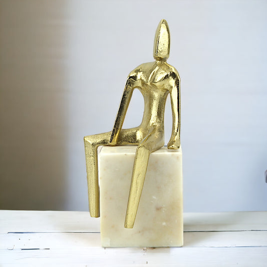 Golden Aluminum Sitting Man Sculpture: Handcrafted Art on White Marble Base